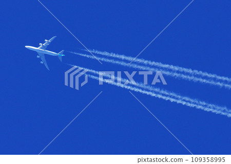 Jumbo jet flying in the blue sky and contrail Jumbo jet flying in the blue sky and contrail 109358995