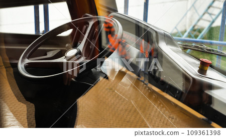 The cab of the world's largest dump truck. Steering wheel, dashboard and other controls. Payload 450 tonnes. View through the glass. The cab of the world's largest dump truck. Steering wheel, dashboard and other controls. Payload 450 tonnes. View through the glass. 109361398