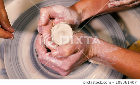 Close-up of a potter working on a wheel. An open class is in progress. The concept of manual work, art and craft. 109361407