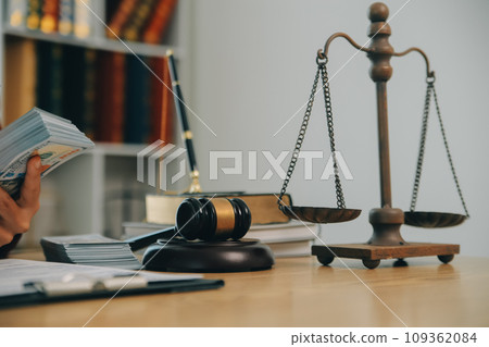 Lawyer, legal advisor, businessman brainstorming information on agreement details Business contracts in legal processing books for accuracy in contract documents. joint financial investment. 109362084