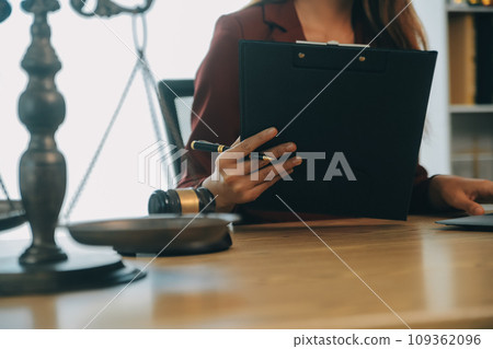 Lawyer, legal advisor, businessman brainstorming information on agreement details Business contracts in legal processing books for accuracy in contract documents. joint financial investment. 109362096