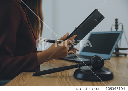 Lawyer, legal advisor, businessman brainstorming information on agreement details Business contracts in legal processing books for accuracy in contract documents. joint financial investment. 109362104