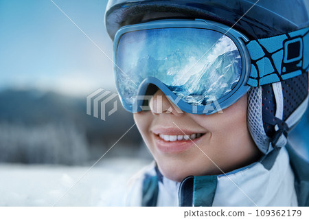 A Mountain Range Reflected In The Ski Mask. Winter Sports. Woman At The Ski Resort On The Background Of Mountains And Blue Sky. 109362179