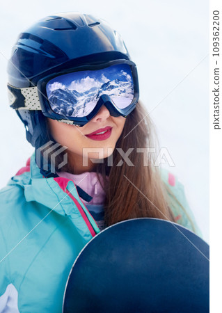Close up Portrait of snowboarder in Carpathian Mountains, Bukovel Snowboarder. A mountain range reflected in the ski mask Close up Portrait of snowboarder in Carpathian Mountains, Bukovel Snowboarder. A mountain range reflected in the ski mask 109362200
