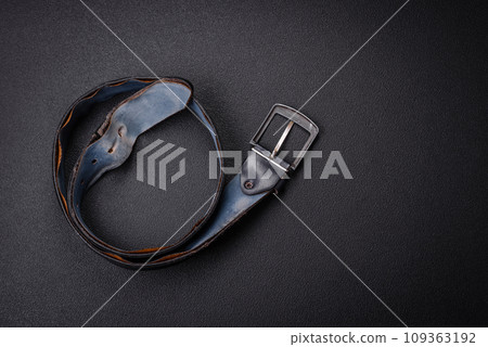 Old leather men's belt with an old-style metal buckle 109363192