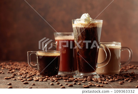 Various coffee and chocolate drinks on a brown background. 109363332