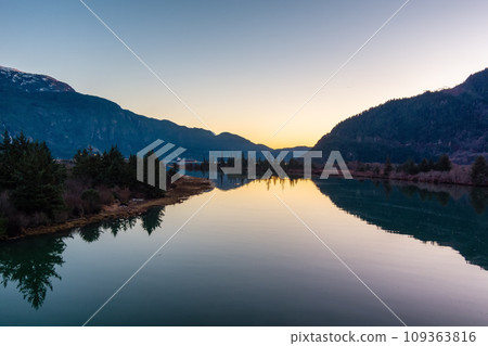 Canadian Mountain Landscape, peaceful river with green trees. Sunny Sunset. 109363816