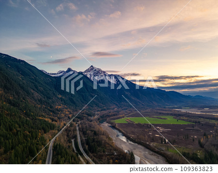 Scenic Road in Valley by the River, surrounded by Mountains. Sunset, Fall Season. Aerial Landscape. 109363823