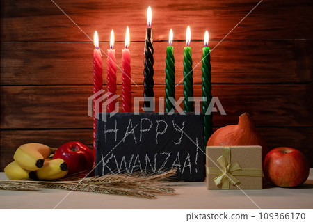 Kwanzaa African American holiday. Seven candles on wooden background. Kwanzaa African American holiday. Seven candles on wooden background. 109366170