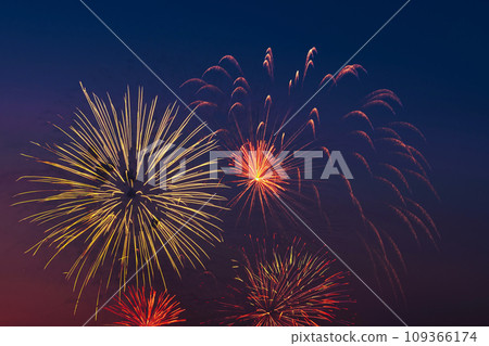 Bright colored fireworks on blue sky background. Bright colored fireworks on blue sky background. 109366174