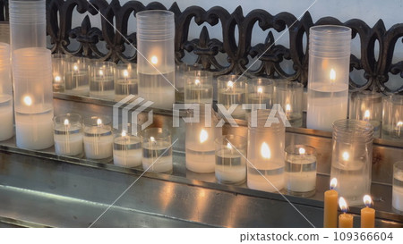 Candles are lit in the Catholic Church. 109366604