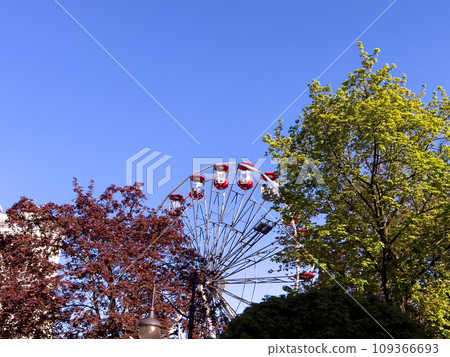 Ferris wheel in the city park on a background of blue sky at Przemysl, Poland 109366693