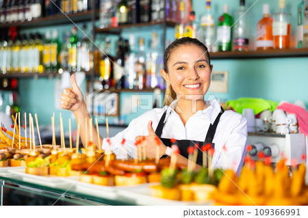 View on the young Latina lady at the food display 109366991