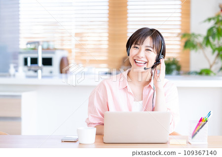 A woman teleworking in the living room. 109367140