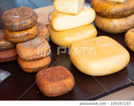 Different types of yellow cheese put on counter in the market 109367287