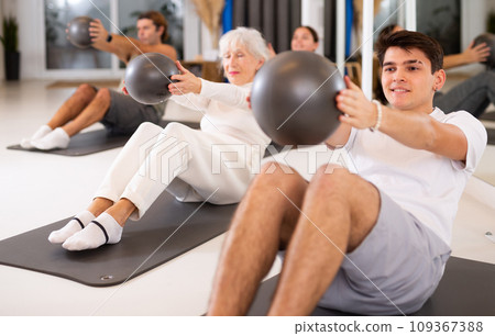 Young boy doing pilates with ball Young boy doing pilates with ball 109367388