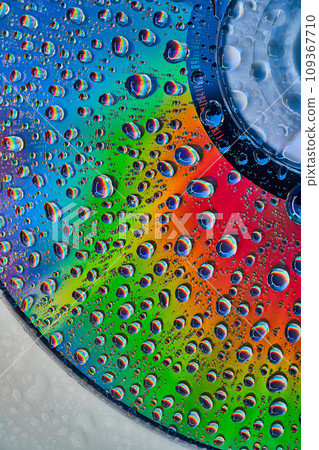Bright and vibrant metallic surface with fizzy bubbles on abstract CD surface in background asset 109367710