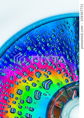 Brilliant burst of rainbow colors on metallic surface with water drops abstract background asset Brilliant burst of rainbow colors on metallic surface with water drops abstract background asset 109367731