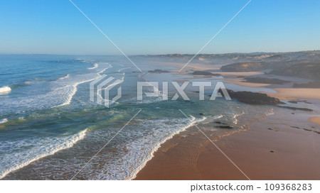 An aerial view of Malyao beach popular for surfing and hiking. Low over the waves in the haze and fog An aerial view of Malyao beach popular for surfing and hiking. Low over the waves in the haze and fog 109368283