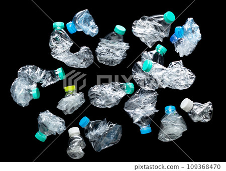 Plastic Bottle fall fly in mid air, pet plastic bottle floating explosion with green lid. Used twist water plastic bottles throw in air. Black background isolated freeze motion high speed shutter 109368470