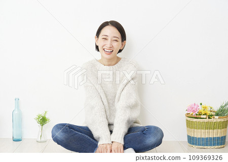 Portrait of middle-aged woman in living room, looking at camera Portrait of middle-aged woman in living room, looking at camera 109369326