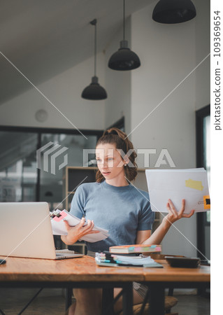 Business woman using business paper for doing math finance on office desk, tax, report, accounting, statistics, and analytical research concept Business woman using business paper for doing math finance on office desk, tax, report, accounting, statistics, and analytical research concept 109369654
