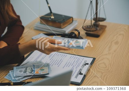 Lawyer, legal advisor, businessman brainstorming information on agreement details Business contracts in legal processing books for accuracy in contract documents. joint financial investment. 109371368