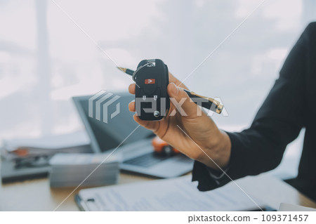 Salesman send key to customer after good deal agreement, successful car loan contract buying or selling new vehicle. 109371457