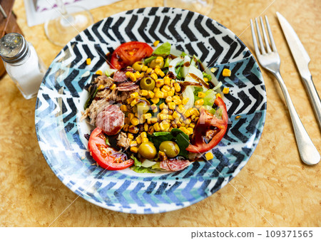 Dish from chef restaurant is Iberian salad of local vegetables and spicy sausages 109371565
