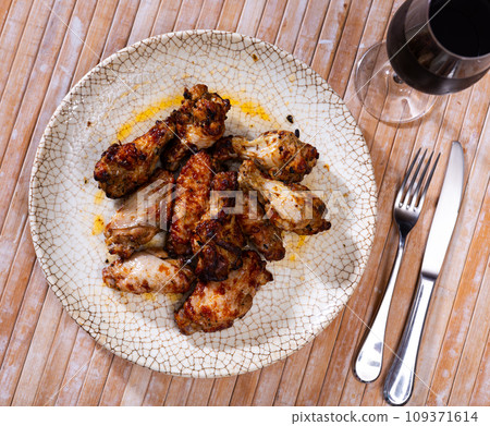 Fried chicken wings served on platter Fried chicken wings served on platter 109371614
