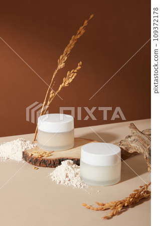 Rice bran powder is displayed with two unlabeled cosmetic jars. Rice bran extract is a botanical ingredient used in cosmetics to condition and soften the skin. Rice bran powder is displayed with two unlabeled cosmetic jars. Rice bran extract is a botanical ingredient used in cosmetics to condition and soften the skin. 109372178