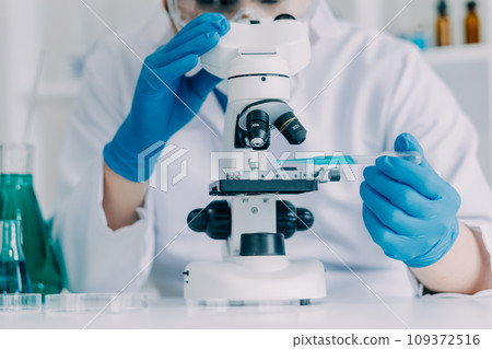biochemical research scientist team working with microscope for coronavirus vaccine development in pharmaceutical research labolatory, selective focus biochemical research scientist team working with microscope for coronavirus vaccine development in pharmaceutical research labolatory, selective focus 109372516