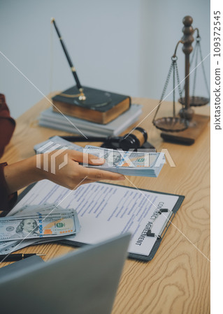 Lawyer, legal advisor, businessman brainstorming information on agreement details Business contracts in legal processing books for accuracy in contract documents. joint financial investment. 109372545