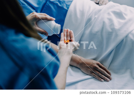 Doctor telling to patient woman the results of her medical tests. Doctor showing medical records to cancer patient in hospital ward. Senior doctor explaint the side effects of the intervention. 109373106