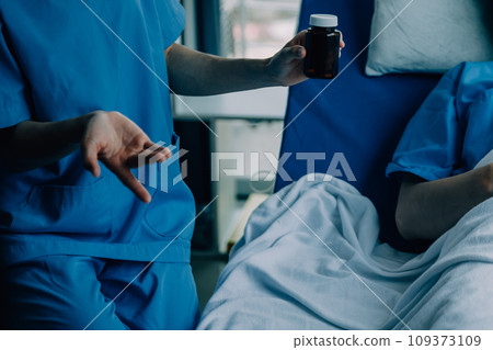 Doctor telling to patient woman the results of her medical tests. Doctor showing medical records to cancer patient in hospital ward. Senior doctor explaint the side effects of the intervention. 109373109