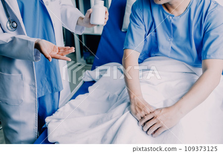 Doctor telling to patient woman the results of her medical tests. Doctor showing medical records to cancer patient in hospital ward. Senior doctor explaint the side effects of the intervention. 109373125