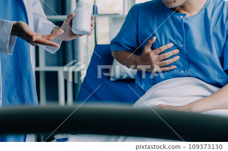 Doctor telling to patient woman the results of her medical tests. Doctor showing medical records to cancer patient in hospital ward. Senior doctor explaint the side effects of the intervention. 109373130