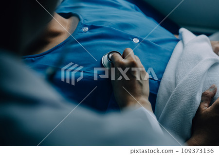 Doctor telling to patient woman the results of her medical tests. Doctor showing medical records to cancer patient in hospital ward. Senior doctor explaint the side effects of the intervention. 109373136