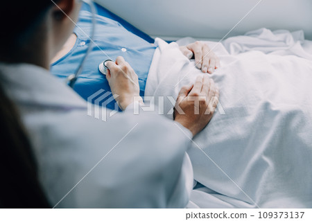 Doctor telling to patient woman the results of her medical tests. Doctor showing medical records to cancer patient in hospital ward. Senior doctor explaint the side effects of the intervention. 109373137