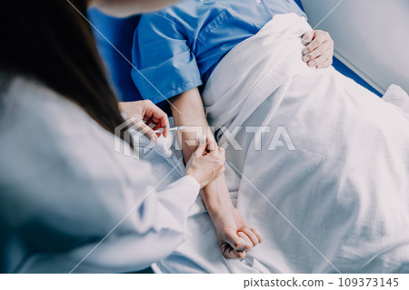 Doctor telling to patient woman the results of her medical tests. Doctor showing medical records to cancer patient in hospital ward. Senior doctor explaint the side effects of the intervention. 109373145