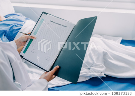 Doctor telling to patient woman the results of her medical tests. Doctor showing medical records to cancer patient in hospital ward. Senior doctor explaint the side effects of the intervention. 109373153