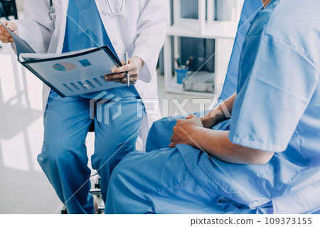 Doctor telling to patient woman the results of her medical tests. Doctor showing medical records to cancer patient in hospital ward. Senior doctor explaint the side effects of the intervention. 109373155