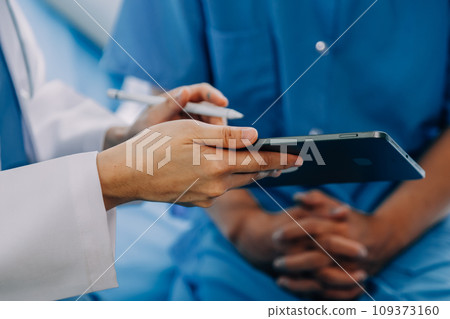 Doctor telling to patient woman the results of her medical tests. Doctor showing medical records to cancer patient in hospital ward. Senior doctor explaint the side effects of the intervention. 109373160