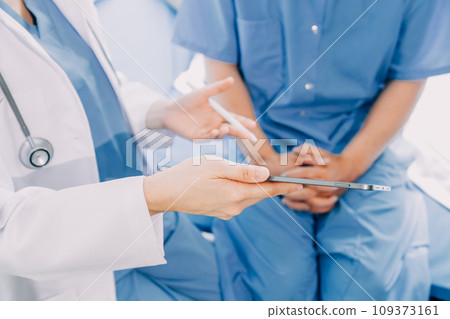 Doctor telling to patient woman the results of her medical tests. Doctor showing medical records to cancer patient in hospital ward. Senior doctor explaint the side effects of the intervention. 109373161