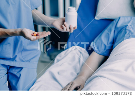 Doctor telling to patient woman the results of her medical tests. Doctor showing medical records to cancer patient in hospital ward. Senior doctor explaint the side effects of the intervention. 109373178