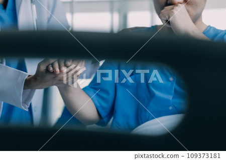 Doctor telling to patient woman the results of her medical tests. Doctor showing medical records to cancer patient in hospital ward. Senior doctor explaint the side effects of the intervention. 109373181