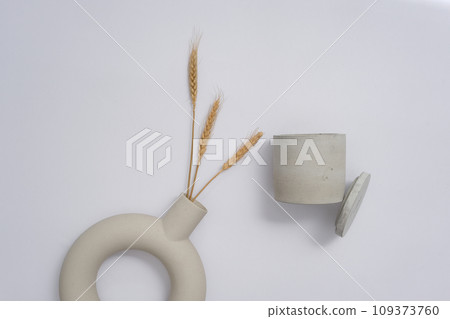 An open jar of unbranded scented candles is displayed on a white background with decorations. Empty space for text design. Scented candles are commonly used to scent a space. 109373760