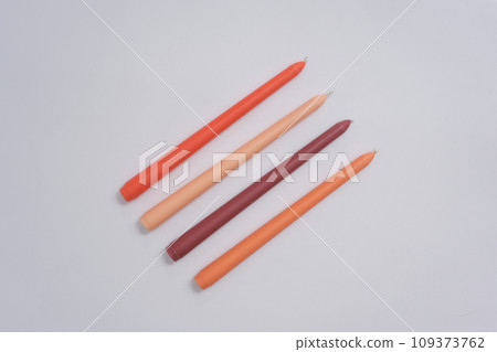 View from above of four candles with four different colors isolated on white background. Empty space for text design. Copy space for ads. Creative space. 109373762