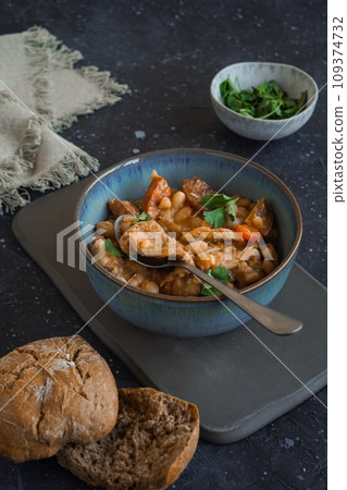 Tripas- Tripe stew with bread on the black background 109374732