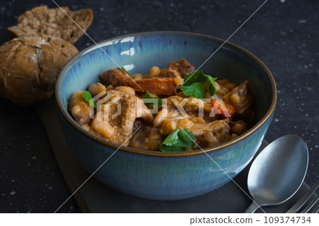 Tripas- Tripe stew with bread on the black background 109374734